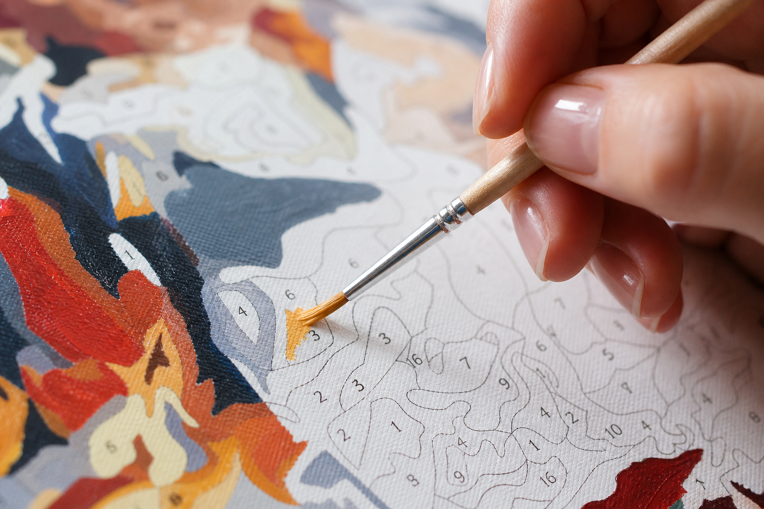 Hand painting a small numbered section on a mini paint by numbers canvas