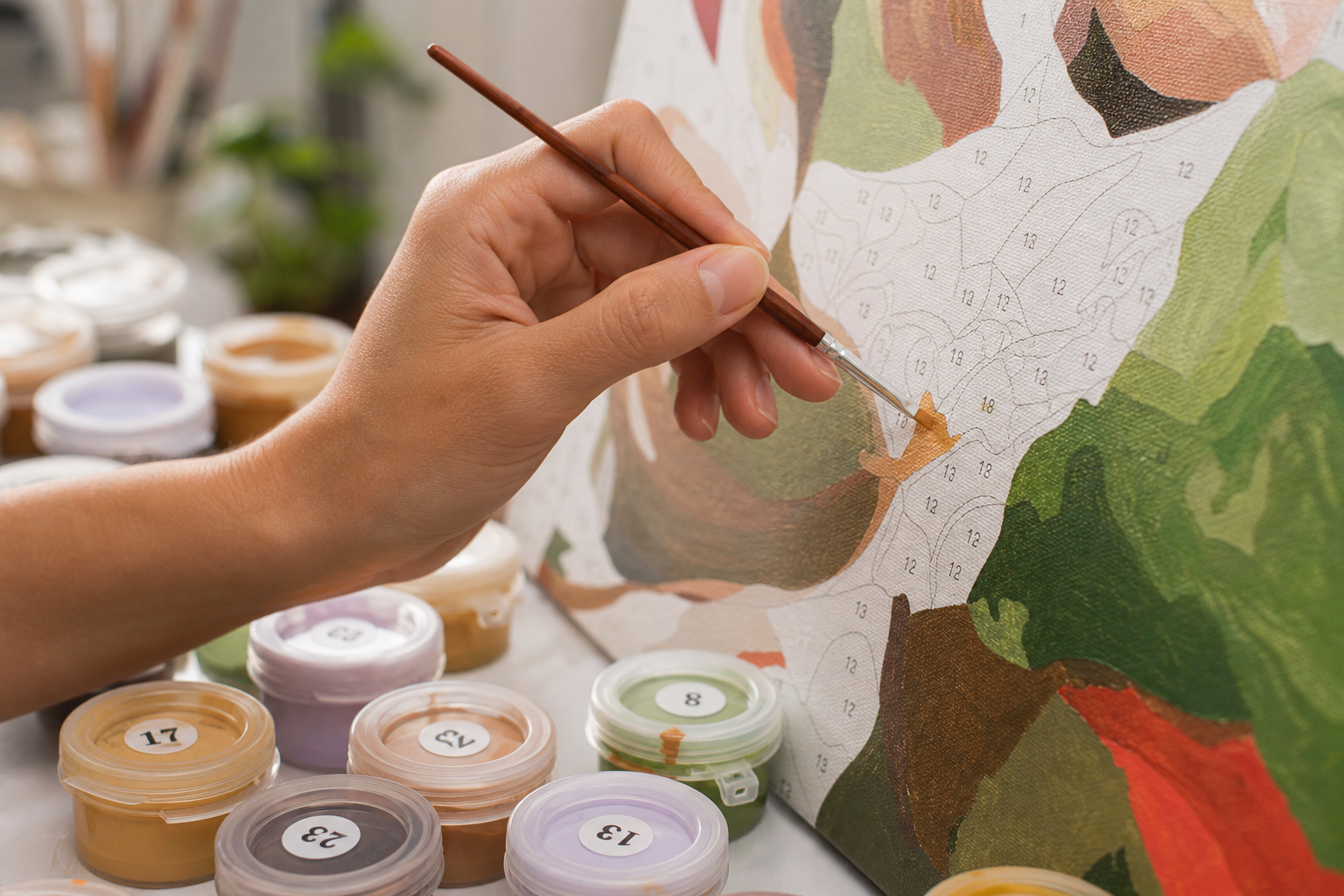 Close up of a hand painting a textured paint by numbers canvas