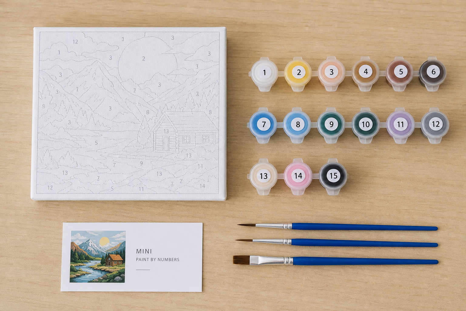 Contents of a mini paint by numbers kit including canvas, paints, and brushes